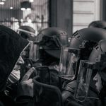 grayscale photo of motorcycle helmet and helmet